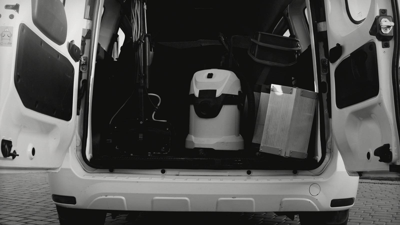 A service van with its back doors open, gear loaded